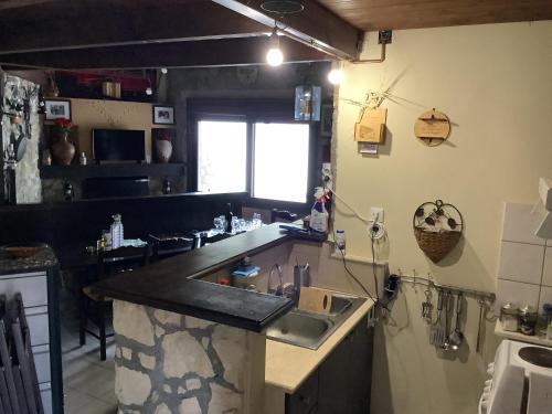 a kitchen with a sink and a counter top at Εθιά Παραδοσιακή πετρόχτιστη οικία Ethia Traditional house of stone in Ethiá