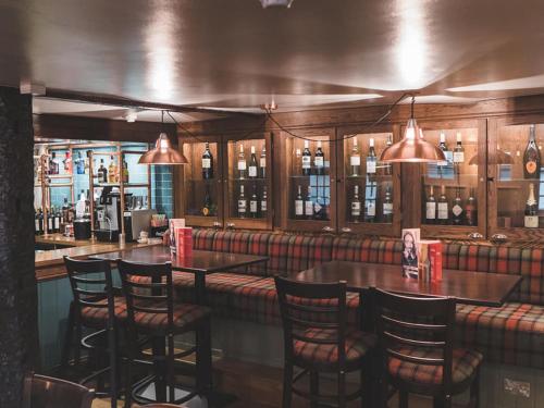 a bar with chairs and a table in a restaurant at The Olde Kings Arms in Hemel Hempstead