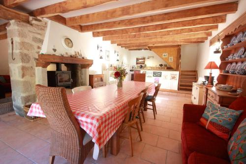 a kitchen and dining room with a table and chairs at Le Moulin de Pensol in Pensol