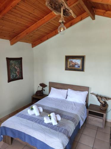 a bedroom with a bed with towels on it at Anatolika Stamatis Paradise in Dhémbla