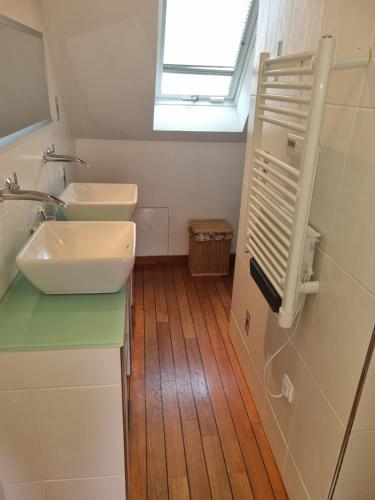 a bathroom with two sinks and a window at Appartement familial avec balcon in Trosly-Breuil