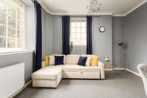 a living room with a couch and a window at 2 BR Royal Mile Apartment in Edinburgh