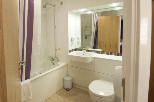 a bathroom with a toilet, sink, and shower at Premier Inn London Heathrow Airport T2 & T3 - Bath Road in Hillingdon
