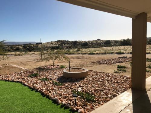 a rock garden with a tub in the middle of a yard at Daberas Guest Farm in Augrabies