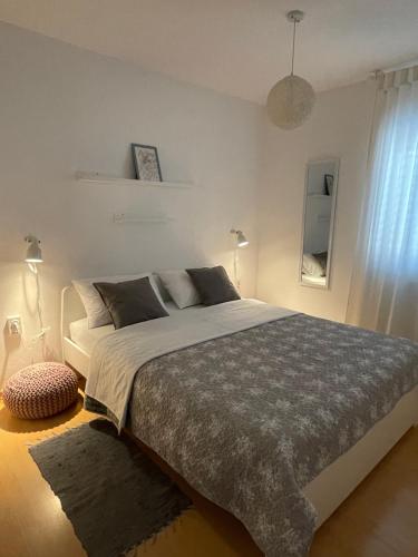 a bedroom with a large bed and a window at Sol Apartment in Baška