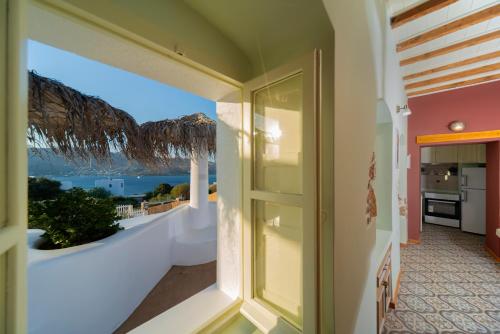 a room with a balcony with a view of the ocean at Hidden Oasis Private Villa in Agia Marina