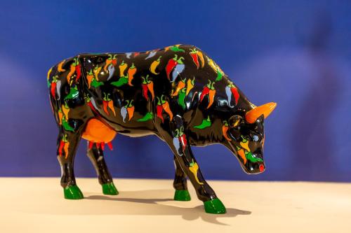 a plastic figurine of a cow on a table at Hotel Spicy in Sorrento