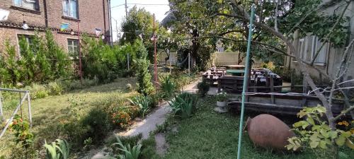 a garden with flowers and plants in a yard at Guest House Tall Rooms in Zugdidi