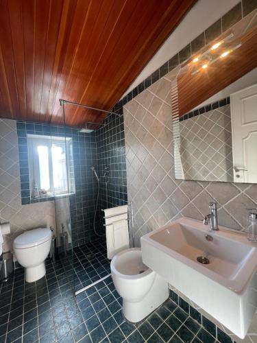 a bathroom with a white toilet and a sink at The White Sail - Mondello Apartment with Terrace - casa di vincenzo e andrea in Mondello