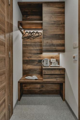 a kitchen with wood paneled walls and a counter at Hotel Vladimir in Budva