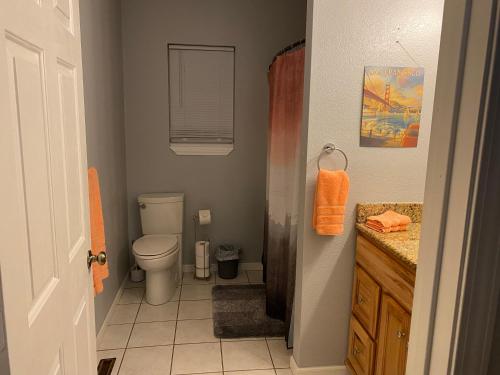 a bathroom with a toilet and a sink at Cozy house with large free parking on premises in Springfield