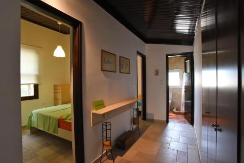 a bedroom with a bed and a hallway with a mirror at Casa Mykines 