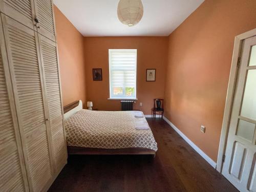 a bedroom with a bed and a window in it at Old Lviv Apartment in Lviv