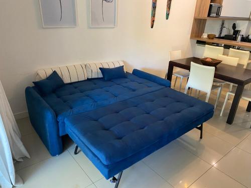a blue couch in a living room with a table at Green Park in Punta del Este