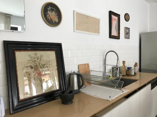 a kitchen counter with a sink and a picture on it at Medusa house in Esztergom