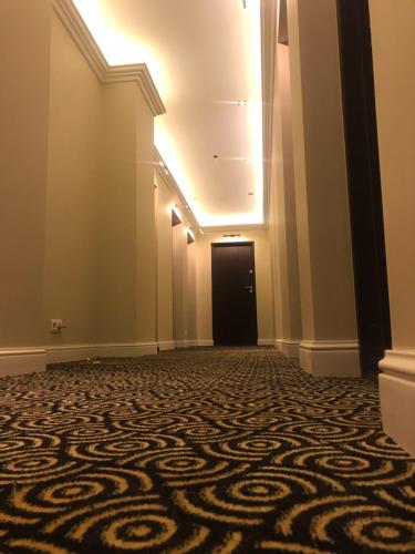 an empty hallway with a door and a carpet at President Apartments by WarsawResidence Group in Warsaw