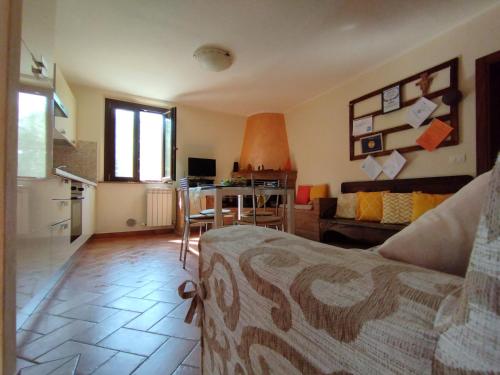 a living room with a couch and a table at La Casa Tra Gli Ulivi in Cortona