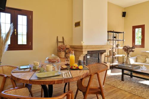 a living room with a table and a fireplace at COCO in Venaco