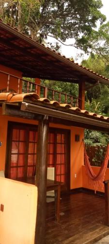 a porch of a house with a roof at Casa da Ilha Inn, Ilha Grande in Abraão