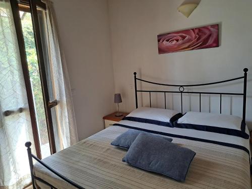 a bedroom with a bed with two pillows on it at Villetta Pia in Contignano