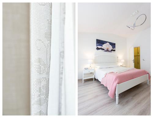 a white bedroom with a bed and a desk at San Giovanni Apartment in San Gimignano