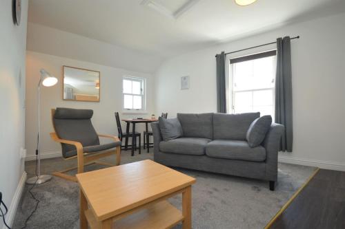 a living room with a couch and a table at Buzzard Apartment in Tobermory
