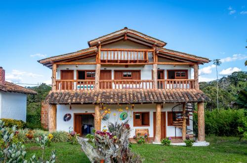 a wooden house with a deck on top of it at Hotel Estorake San Agustin Huila in San Agustín