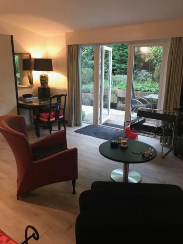 a living room with a couch and a table at Villa 't Haasduin in Wijk aan Zee