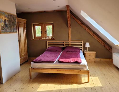 a bedroom with a bed with purple sheets on it at Haus Schmeile in Magdeburg