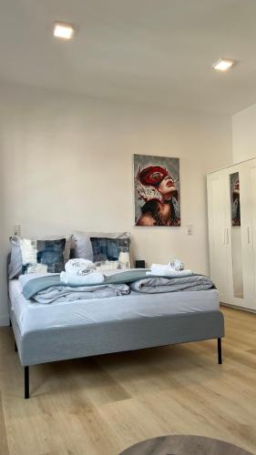 a bedroom with a large bed with blue sheets at My Apartment im Bremer Viertel in Bremen