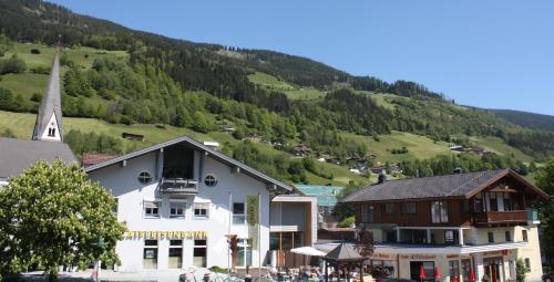 a town with a church and a mountain at Haus Hofer in Bramberg am Wildkogel