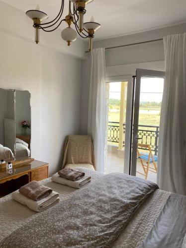 A bed or beds in a room at Polys Apartment and Paraskevi studio with view
