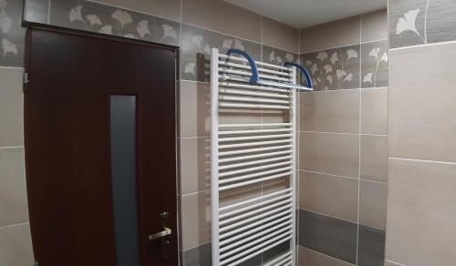 a bathroom with a walk in shower with a door at Max in Liptovský Mikuláš