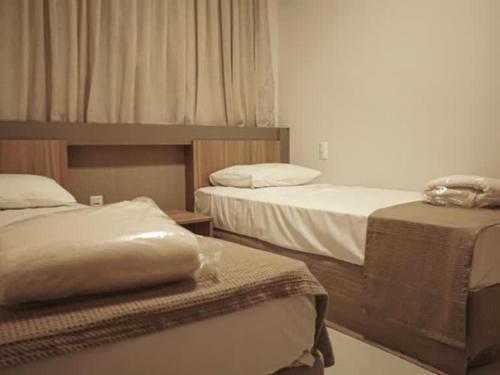 two beds in a room with two beds sidx sidx sidx at Resort Praias do Lago in Caldas Novas