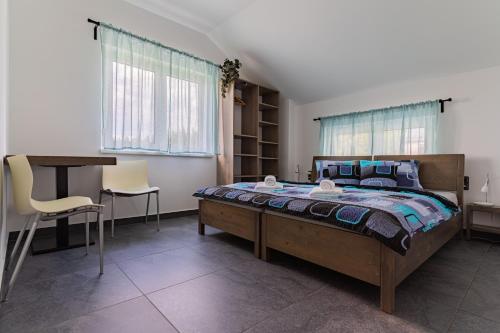 a bedroom with a bed and a table and chairs at APARTMÁNY POD SJEZDOVKOU in Abertamy