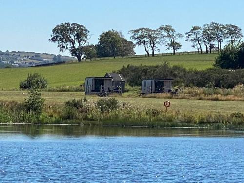 two campgrounds next to a body of water at Couston Lakes Resorts in Bathgate