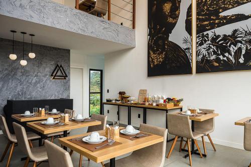 - un restaurant avec des tables et des chaises en bois dans une chambre dans l'établissement Triângulo Noronha, à Fernando de Noronha