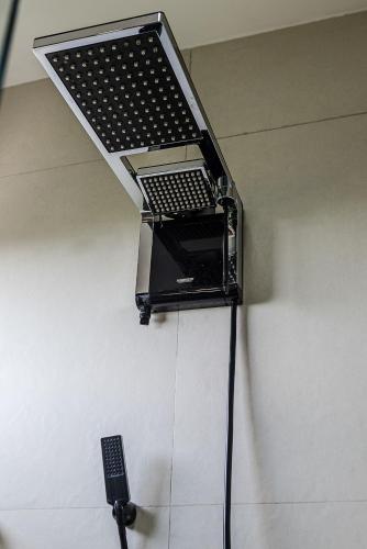 a laptop hanging from a wall with a remote control at Triângulo Noronha in Fernando de Noronha