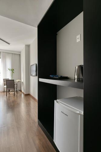 a kitchen with black and white walls and a table at Mercure Belo Horizonte Lourdes in Belo Horizonte
