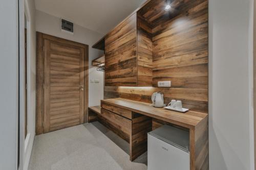 a bathroom with wooden walls and a wooden desk at Hotel Vladimir in Budva