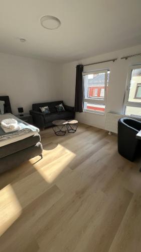 a living room with a black couch and a window at My Apartment im Bremer Viertel in Bremen