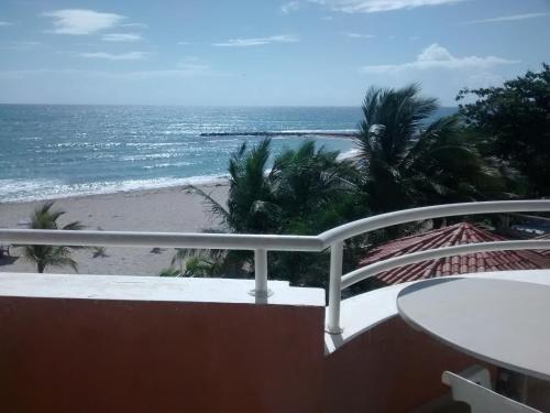 a balcony with a view of the beach at Aparta Hotel Caribe Paraiso in Juan Dolio