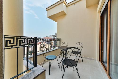 a balcony with a table and chairs on it at Hotel Vladimir in Budva