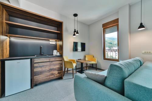 a living room with a couch and a kitchen at Hotel Vladimir in Budva