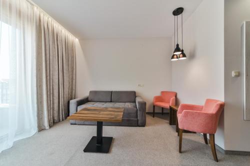a living room with a couch and two chairs at Hotel Vladimir in Budva