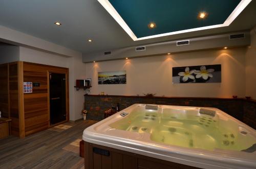 a large bath tub in a bathroom with at Luxury Villa Maslina with private pool & jacuzzi in Šćulci