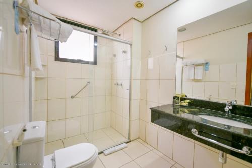 a bathroom with a toilet and a sink at Nobile Inn Executive Ribeirao Preto in Ribeirão Preto