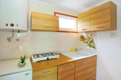 a small kitchen with a stove and a sink at Bungalow close to the beach Sianozety in Sianozety