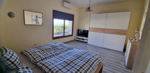 a bedroom with a bed and a television in it at La Casa de Lucy & Karin in La Orotava