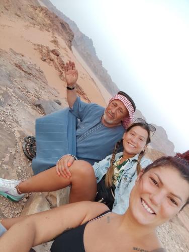 two women and a man laying on the beach at Shakria Bedouin Life Camp in Wadi Rum